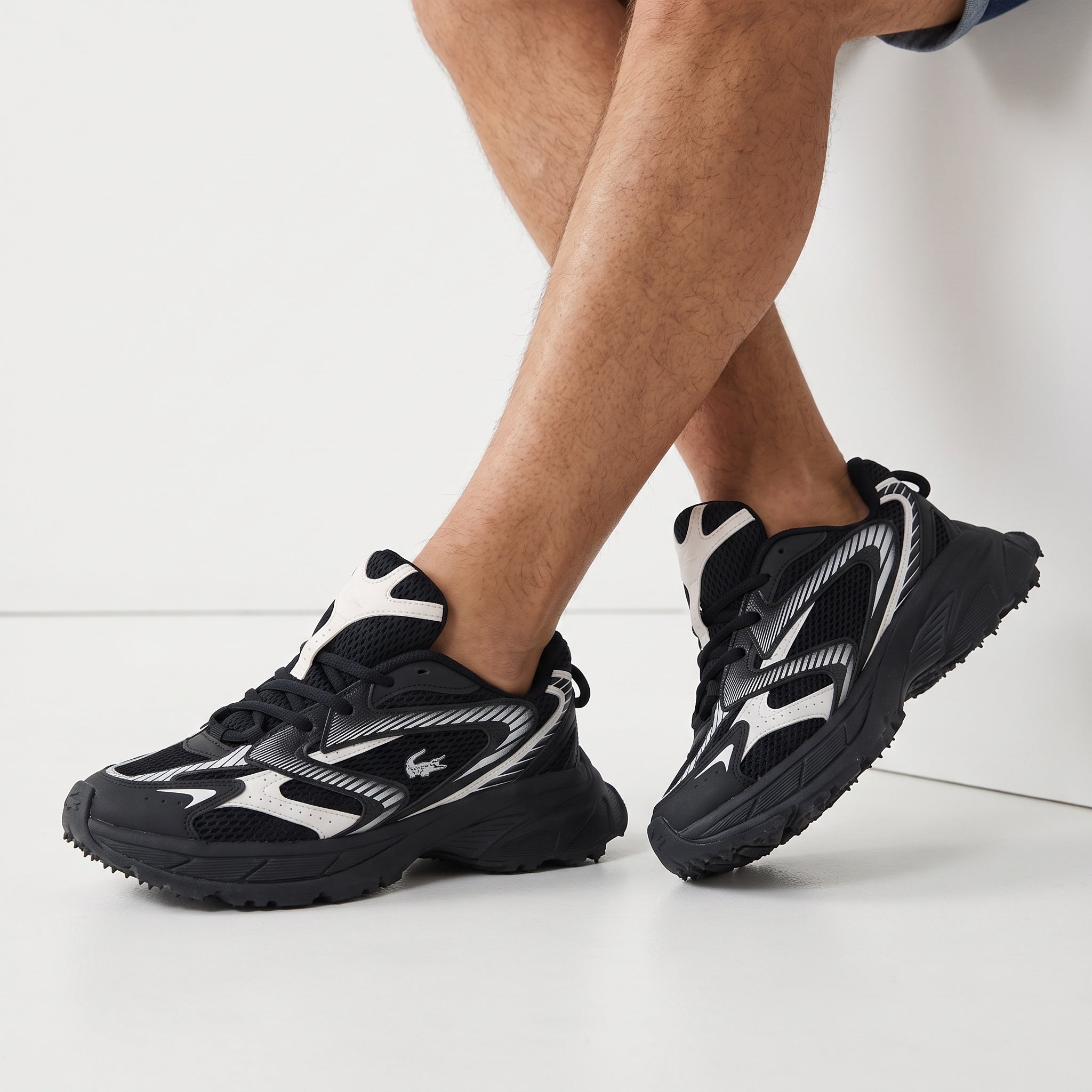 Lacoste black and white chunky low-top sneakers with mesh panels and crocodile logo