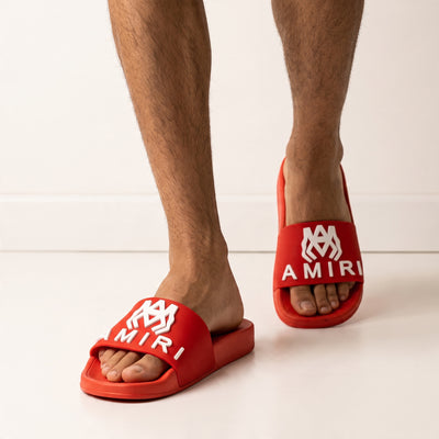 Red Amiri logo slide sandal on model feet