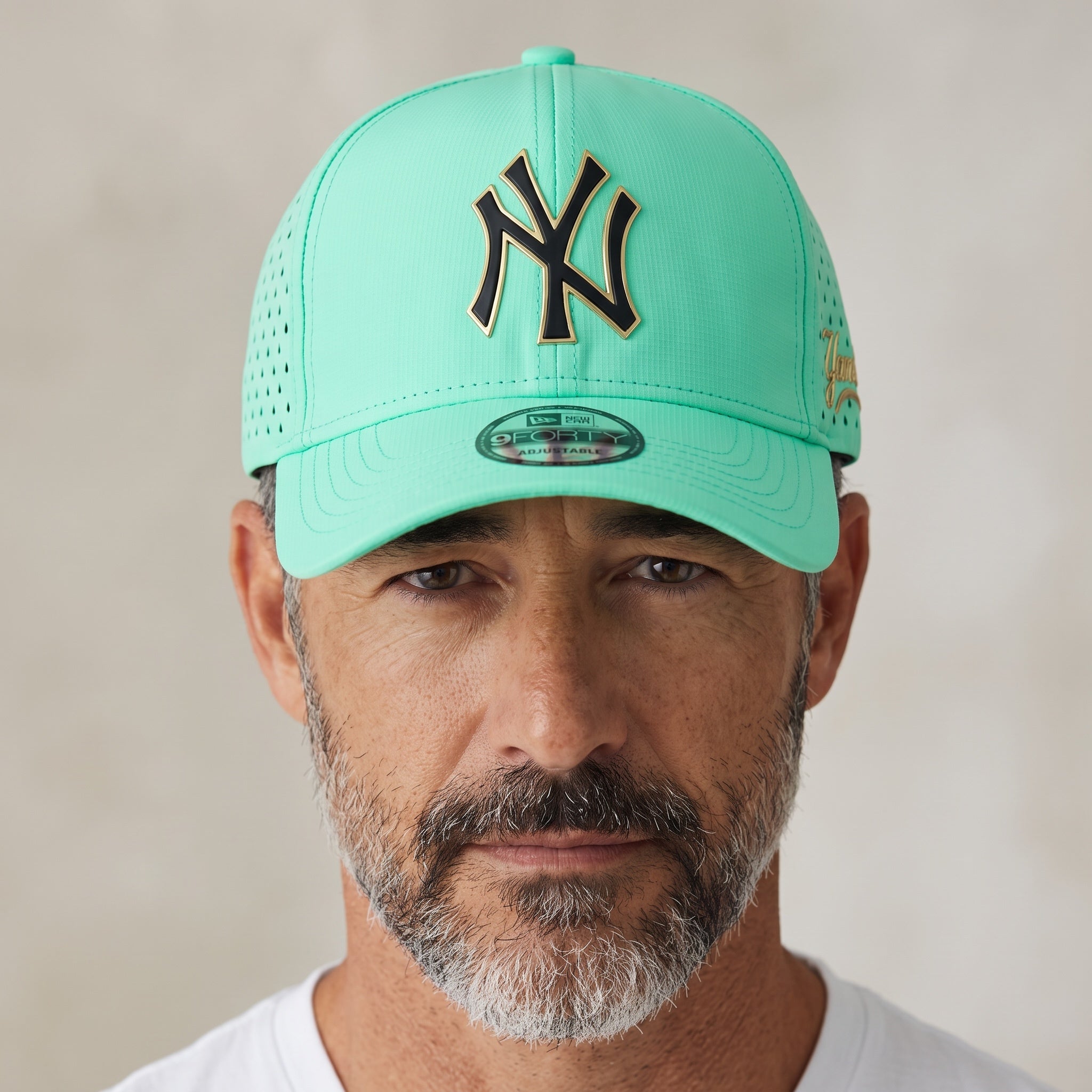 Man wearing a mint green New York Yankees 9Forty baseball cap with gold and black metal logo