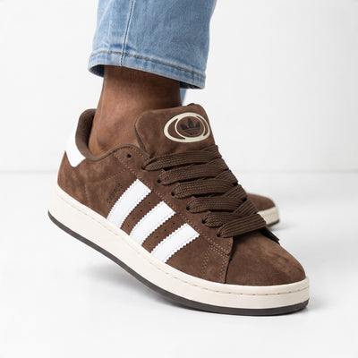 brown Adidas Campus sneaker with white stripes and cream sole