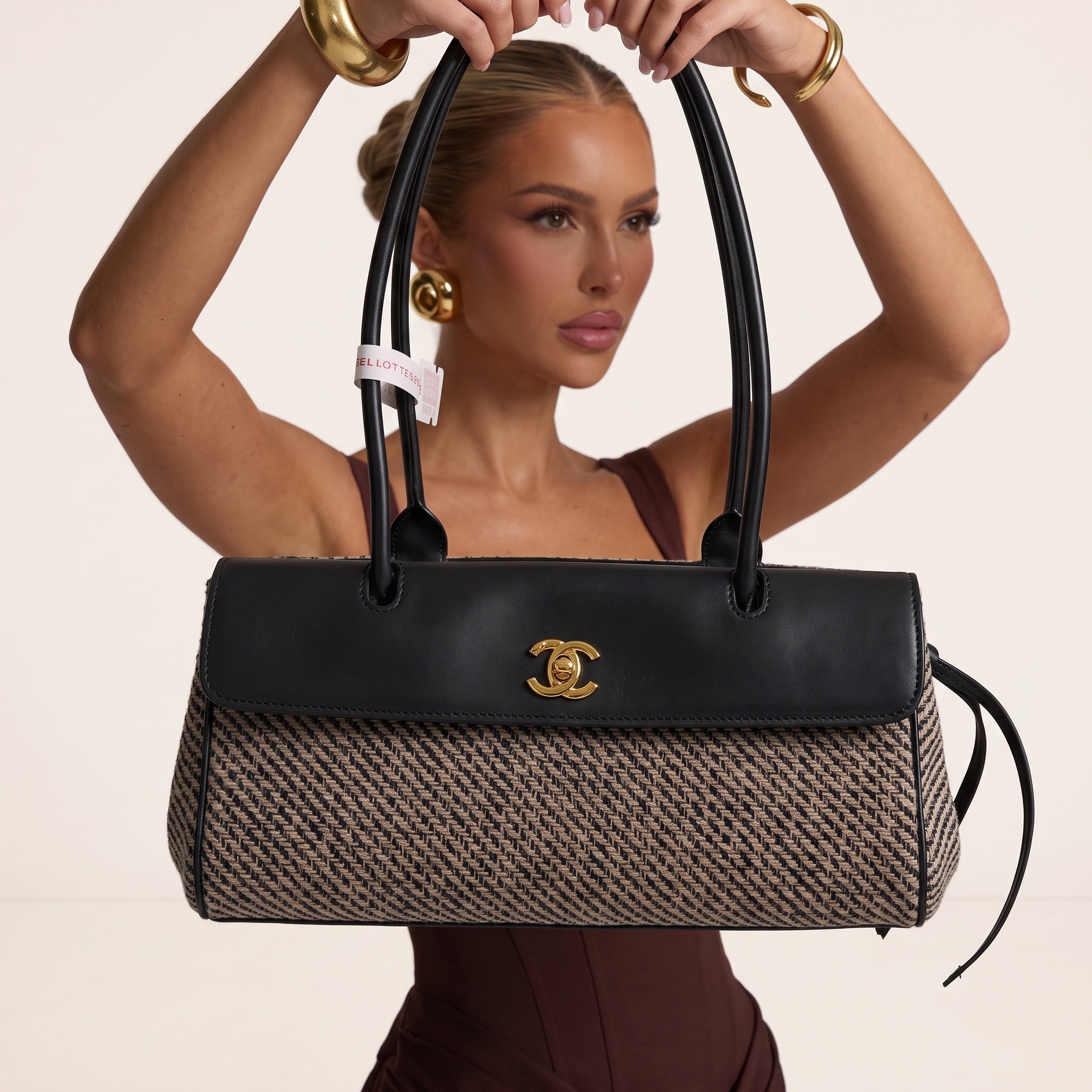 Chanel top-handle bag with black leather flap, gold CC hardware and beige patterned body
