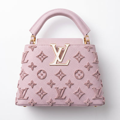 Pink Louis Vuitton Capucines top-handle bag with raised monogram and gold LV plaque
