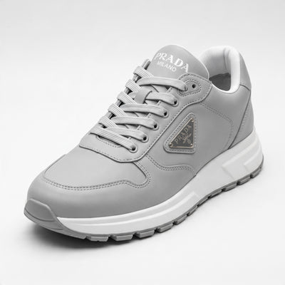 Prada grey low-top sneakers with triangular logo plaque and chunky white sole