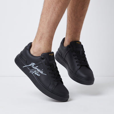 Black Balmain low-top sneakers with script logo on side and branded heel