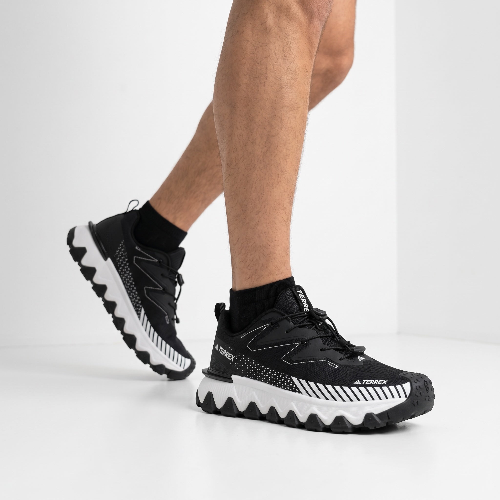 Adidas Terrex black and white trail sneakers with serrated sole
