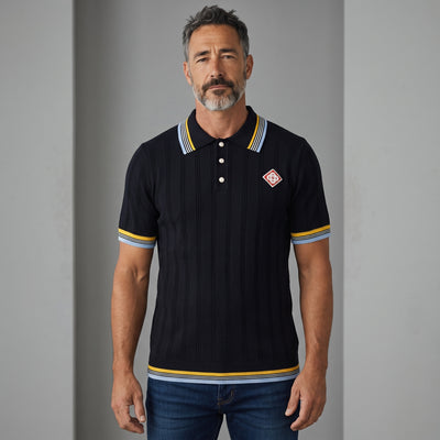 men's navy ribbed polo with striped collar and embroidered chest patch