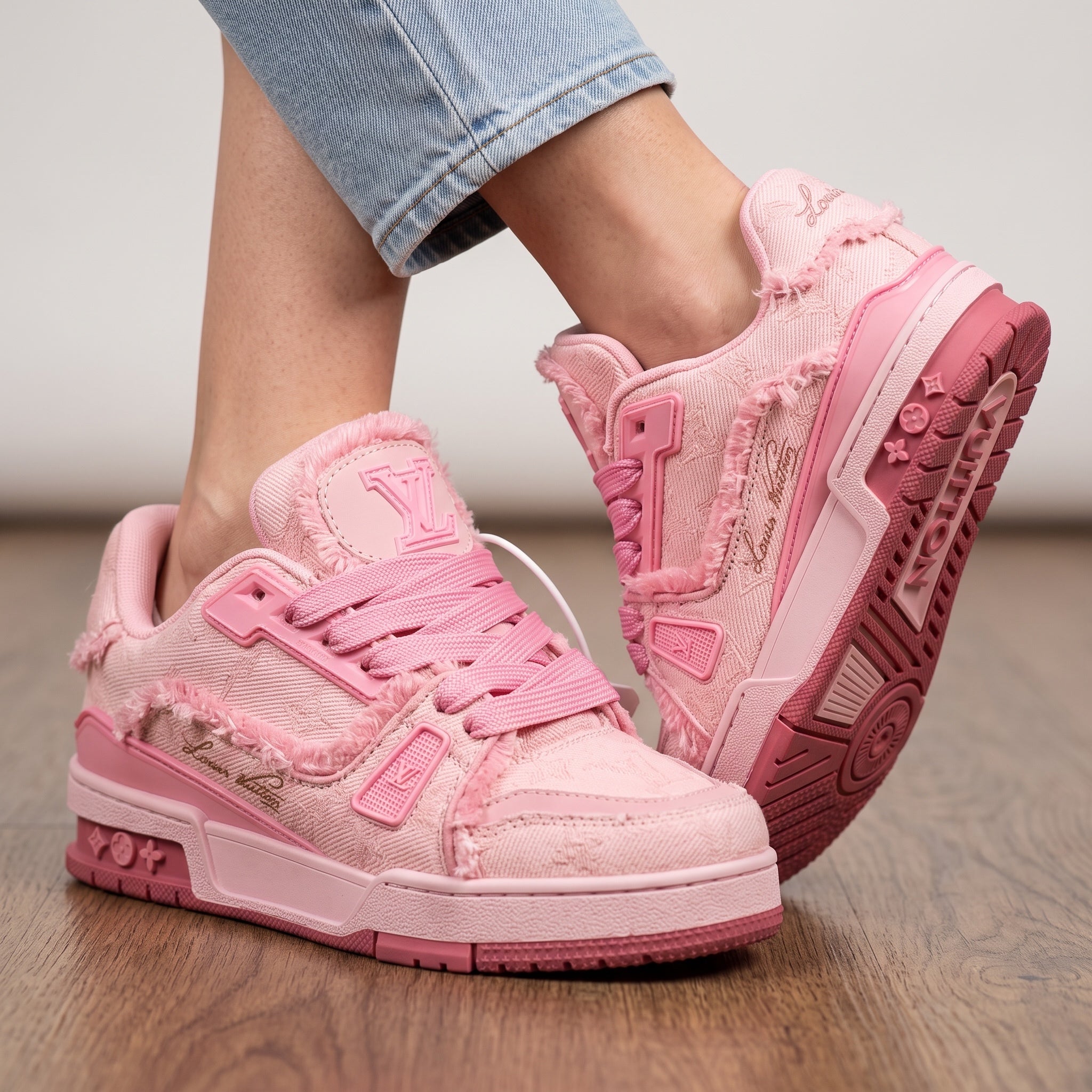 pink Louis Vuitton low-top trainers with frayed trim and LV logo