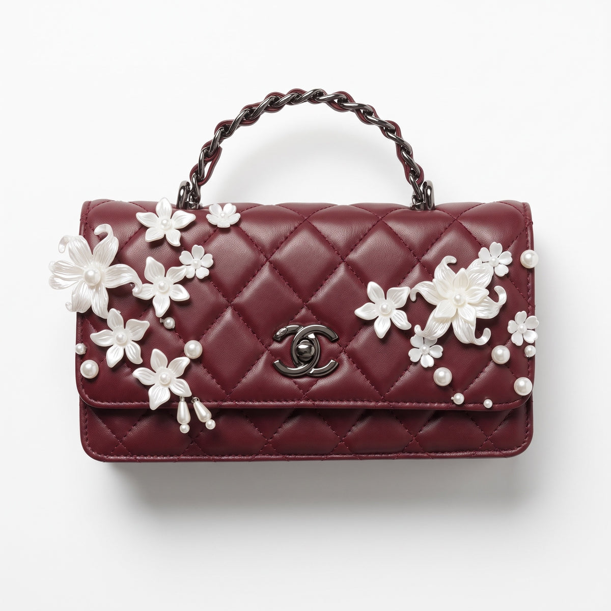 burgundy quilted Chanel top-handle flap bag with pearl floral appliqués and CC turn-lock