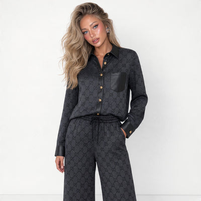 Black Gucci monogram shirt and wide-leg trousers set with contrast trim and gold buttons