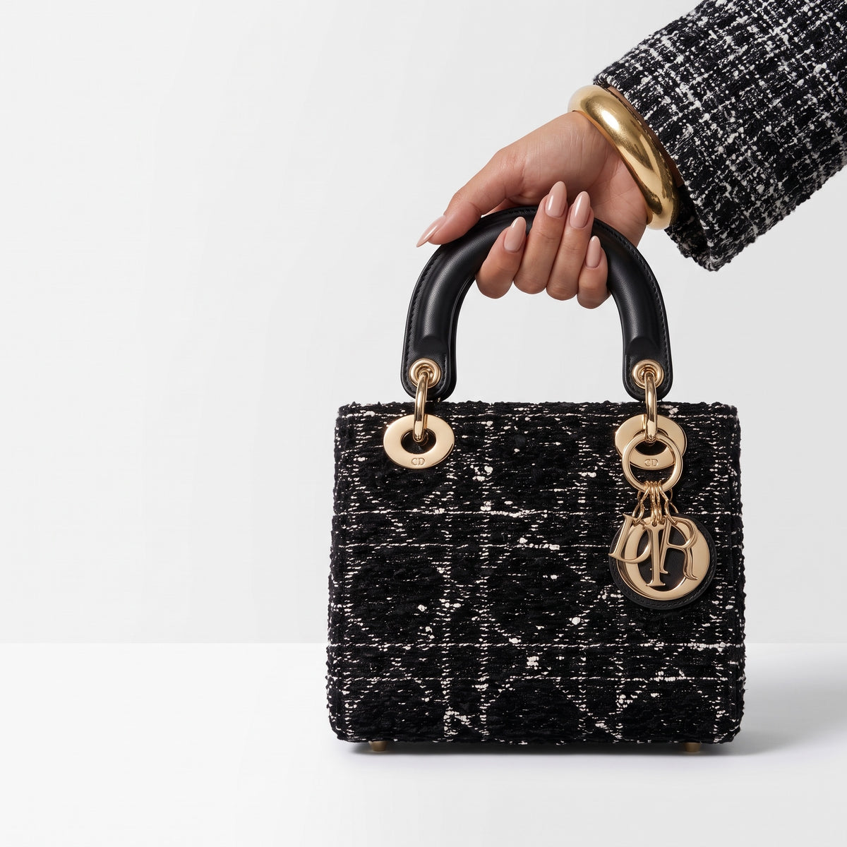 Dior Lady Dior mini top-handle bag in black tweed with gold hardware and Dior letter charms