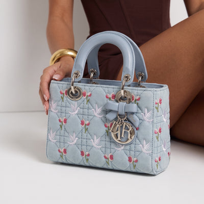 Light blue Dior Lady Dior top-handle bag with floral and dove embroidery and silver charms
