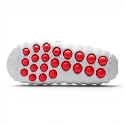 White Nike slip-on clog with perforated upper and red circular outsole pods