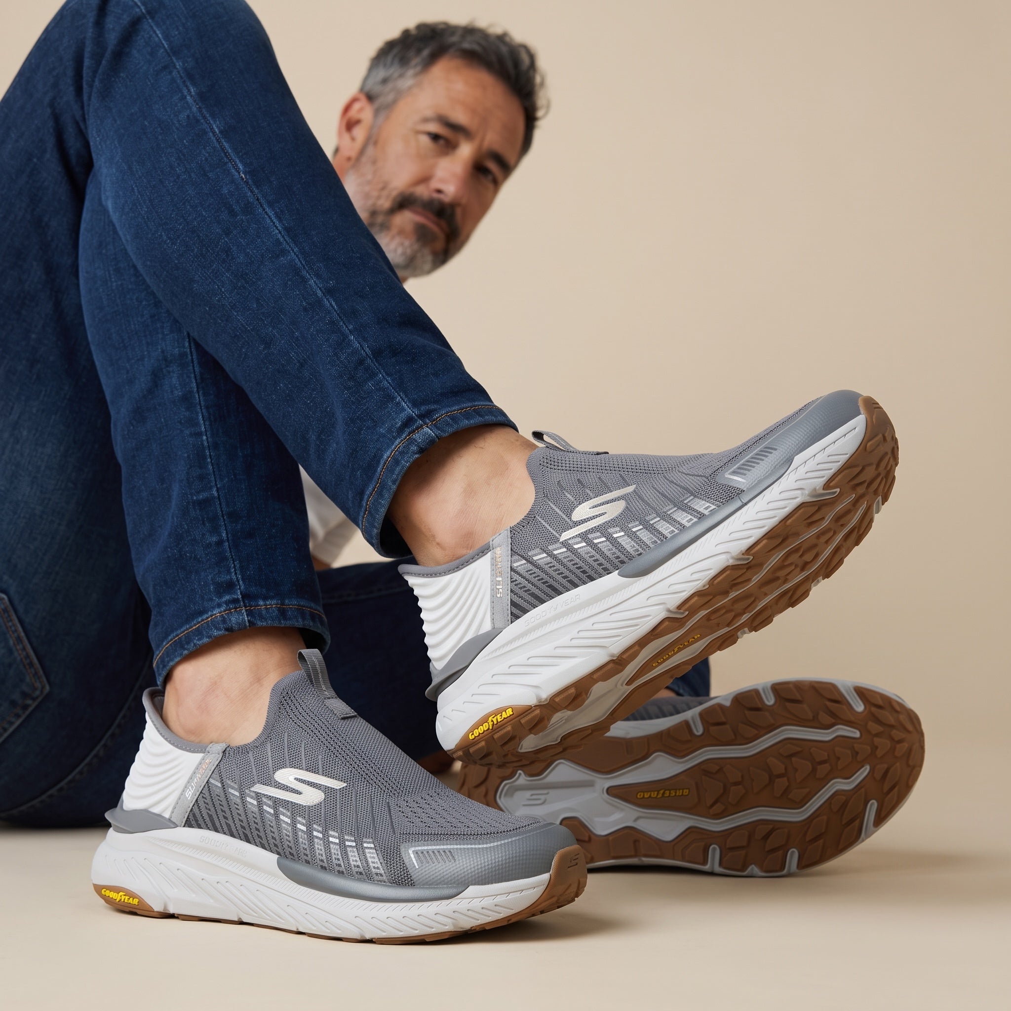 Grey Skechers slip-on knit trainer with white midsole and Goodyear gum outsole