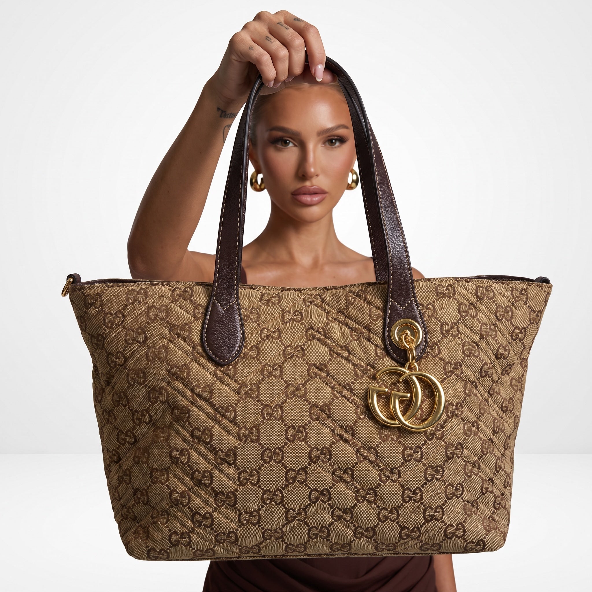 Gucci brown GG monogram tote with double handles and gold charm