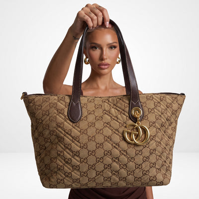 Gucci brown GG monogram tote with double handles and gold charm