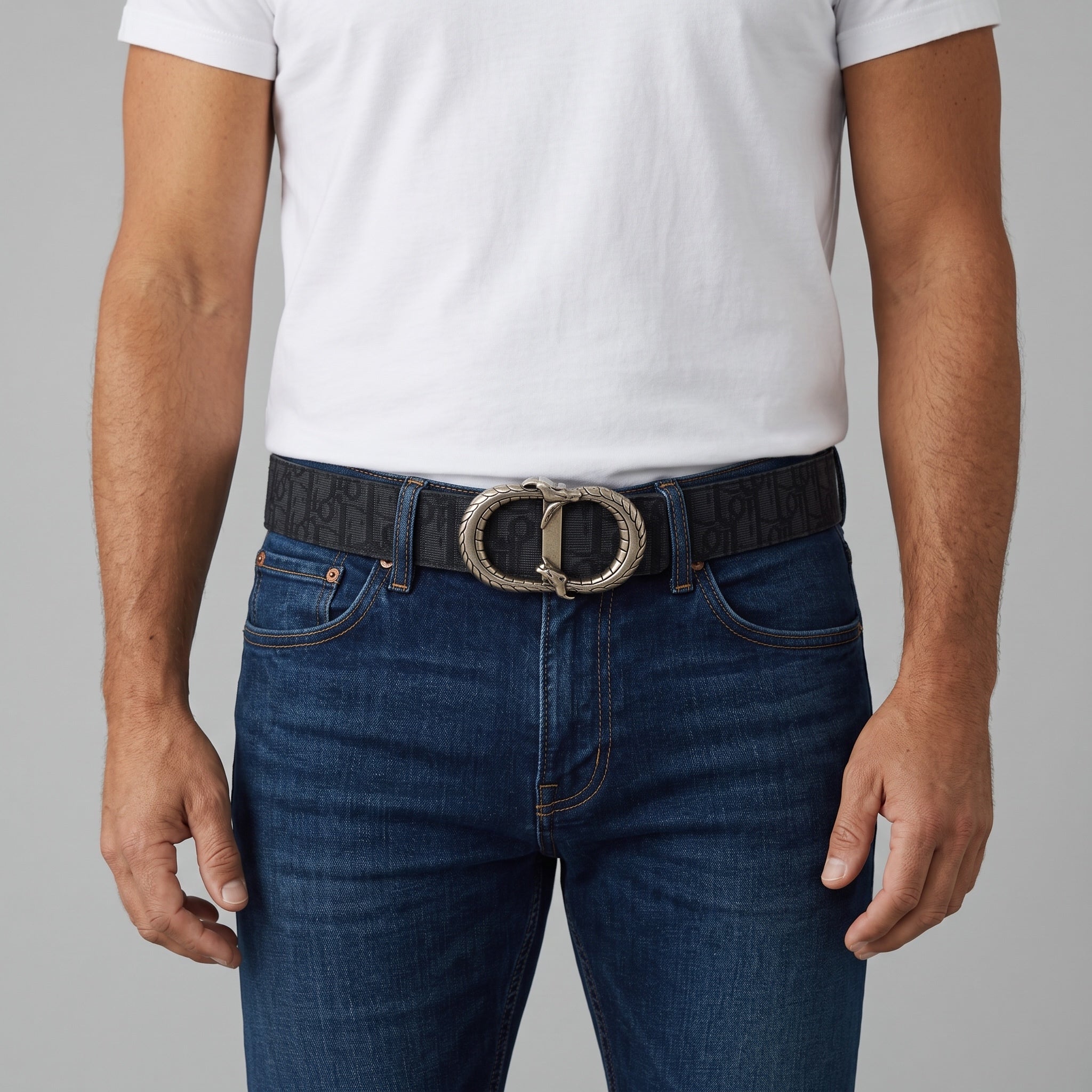 Black monogram belt with silver double-snake buckle worn with jeans