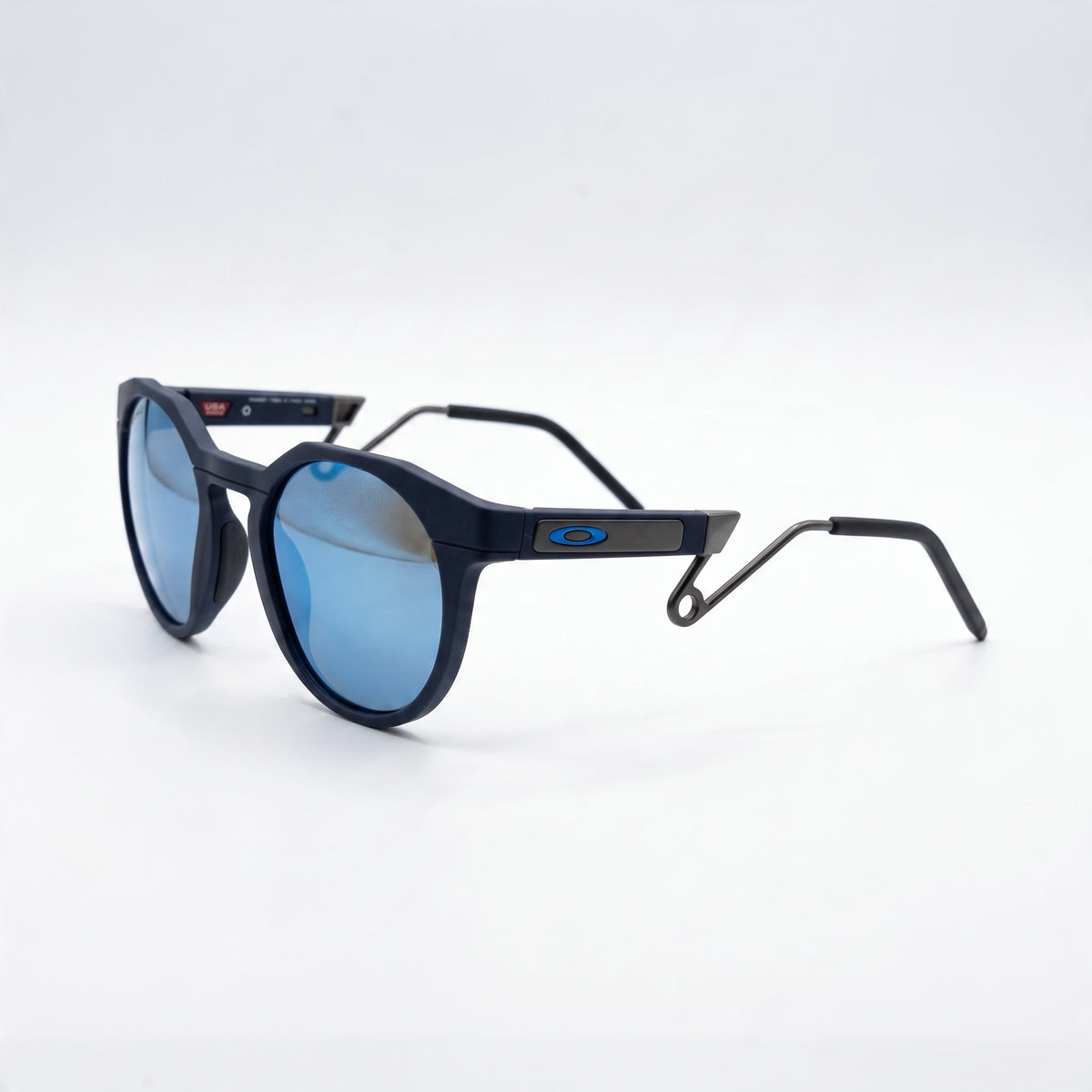 Oakley round sunglasses with matte navy frame and blue reflective lenses