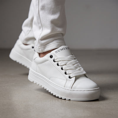 white Numeris platform sneakers with lug sole and black eyelets
