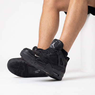 Black Air Jordan 4 Retro with snakeskin pattern and Jumpman tongue logo
