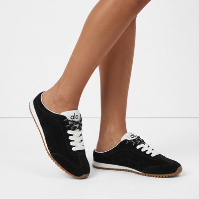 Black low-back Alo sneakers with gum sole and two-tone laces