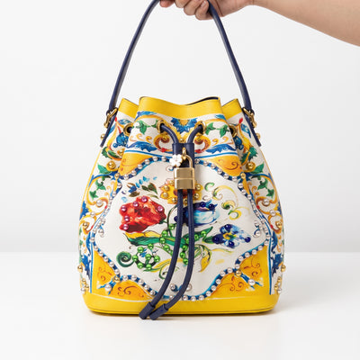 Yellow floral drawstring bucket bag with gold padlock and stud detailing