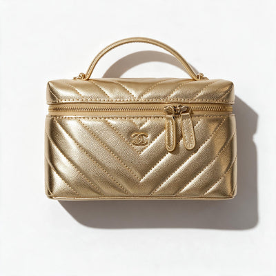 Gold quilted Chanel vanity case with top handle and double zip