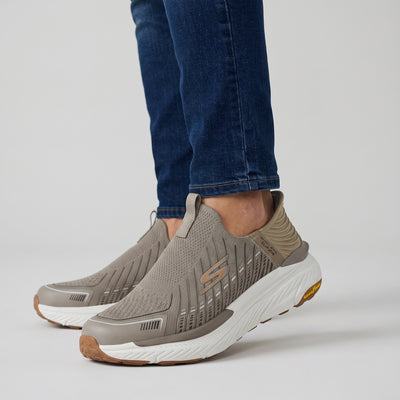 taupe Skechers slip-on knit sneakers with white cushioned sole and Goodyear outsole