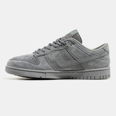 Grey Nike Dunk Low suede sneaker with small red Supreme box logo at heel