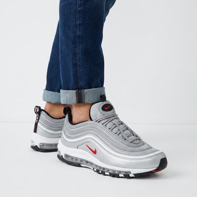 Silver Nike Air Max 97 sneakers with visible Air unit and red Swoosh