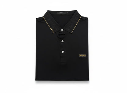 MASTERPIECE BOSS black polo shirt with gold BOSS logo on chest and gold trim on collar. Tailored fit, breathable fabric.