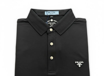 MASTERPIECE black Prada polo shirt with signature chest logo, classic collar, and button placket. Made from breathable stretch fabric.