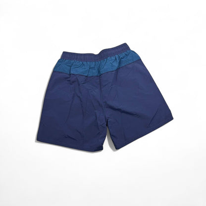 MASTERPIECE blue and dark teal panel swim shorts with yellow drawstring and embroidered logo.