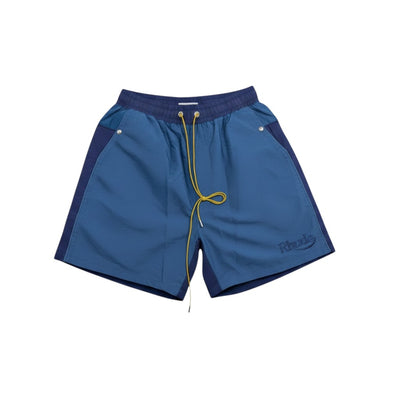 MASTERPIECE blue Rhude swim shorts with darker side panels and yellow drawstring. Embroidered Rhude logo on leg.