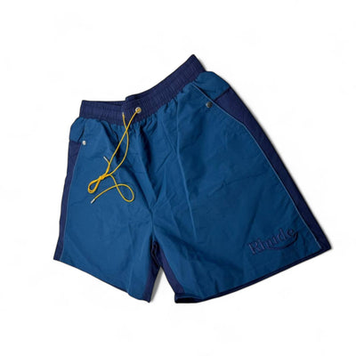 MASTERPIECE Rhude blue panel swim shorts with yellow drawstring and embroidered logo. Lightweight, quick-drying fabric.