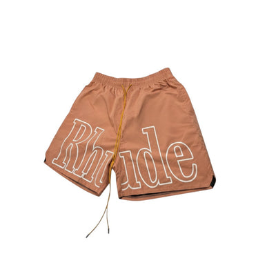 MASTERPIECE Rhude brown swim shorts with oversized white logo and yellow drawstring. Quick-dry fabric, mesh lining.