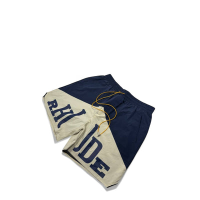 MASTERPIECE navy and cream Rhude panel logo swim shorts with yellow drawstring. Lightweight, fast-drying summer essential.