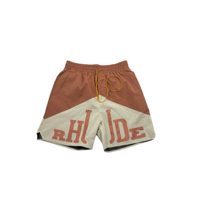 MASTERPIECE Rhude panel swim shorts in rust brown and cream with oversized RHUDE logo and yellow drawstring.