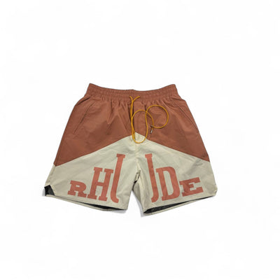 MASTERPIECE Rhude panel swim shorts in rust brown and cream with oversized RHUDE logo and yellow drawstring.
